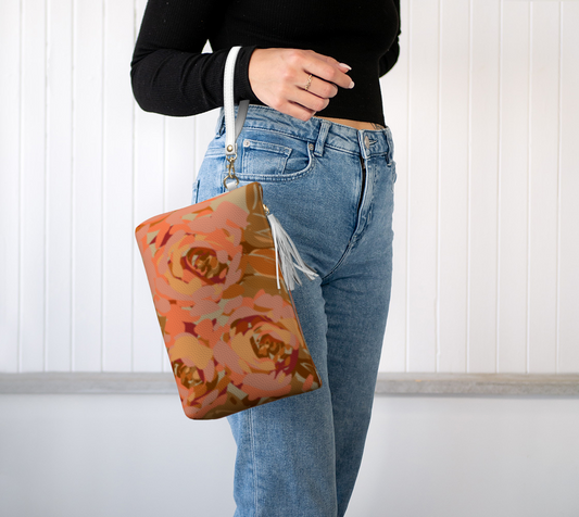 Queen of Petals Copper Sunset Vegan Leather Clutch, worn on wrist with detachable strap