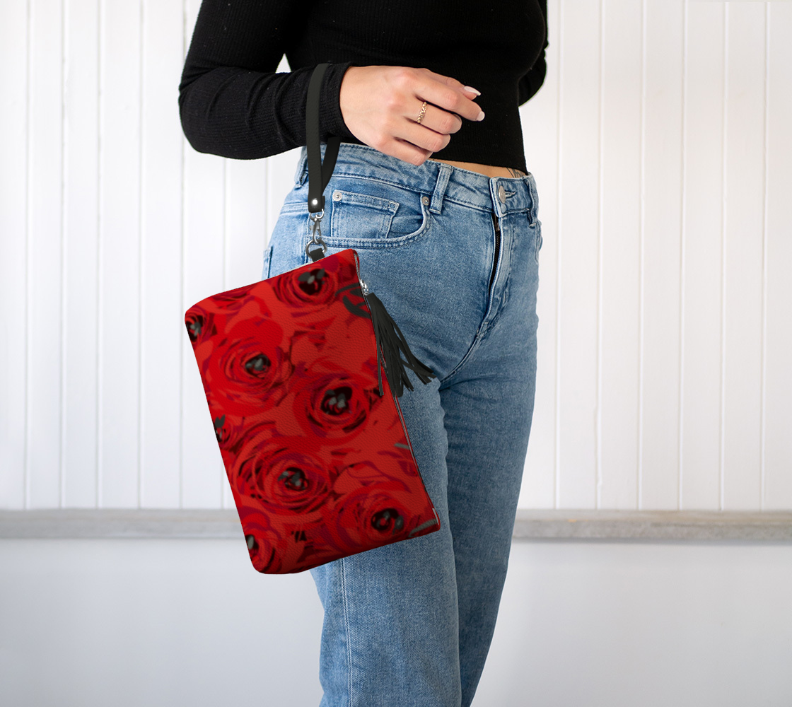 Queen of Petals Ruby Red Roses Vegan Leather Clutch, worn on wrist with detachable strap