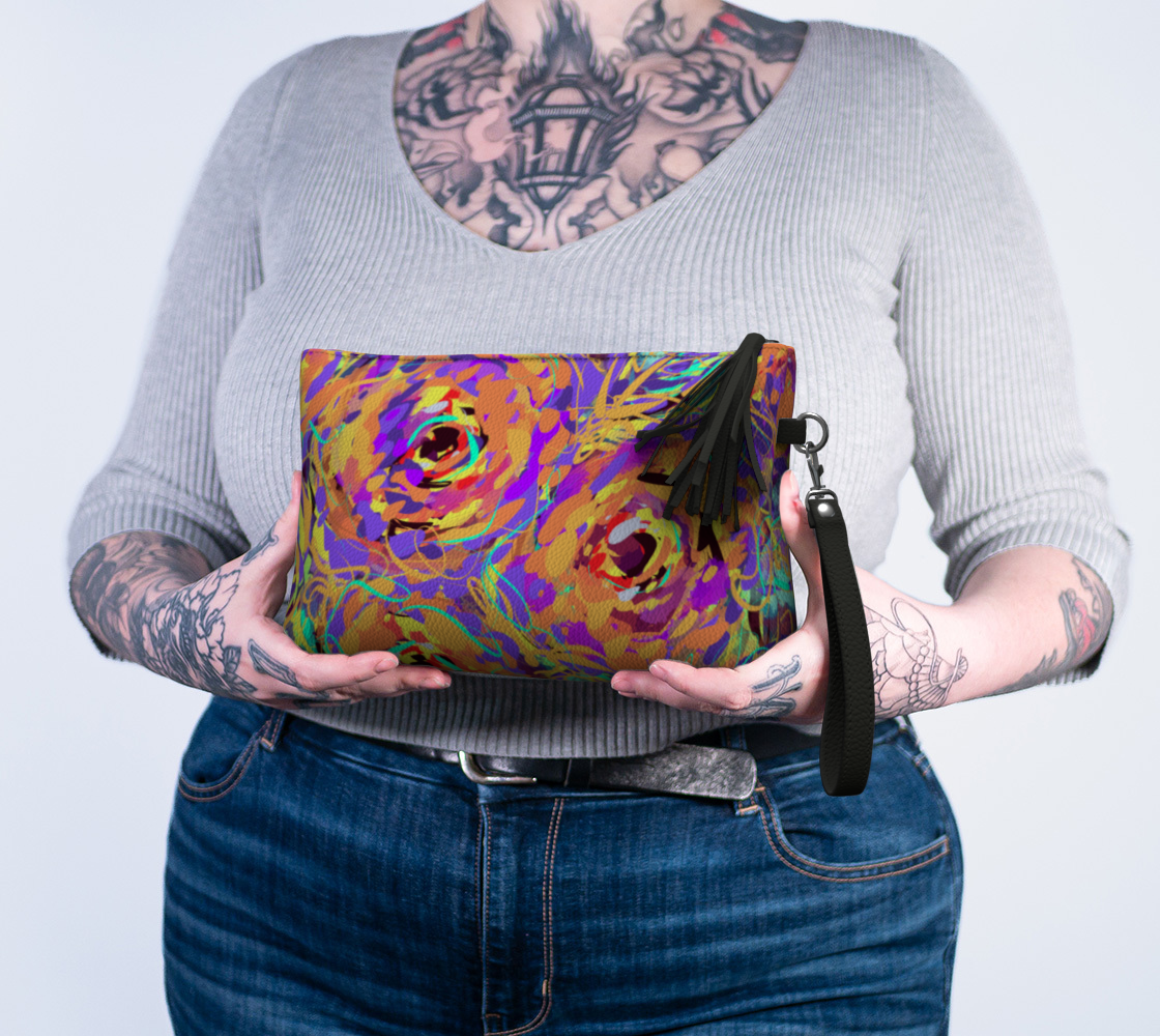 Cordelia Collection Vegan Leather Makeup Bag in Floral, held in hand. Featuring a vibrant rose print and premium vegan leather, this makeup bag is equipped with a heavy-duty zipper, wristlet strap, and chic tassel for easy access to your essentials.