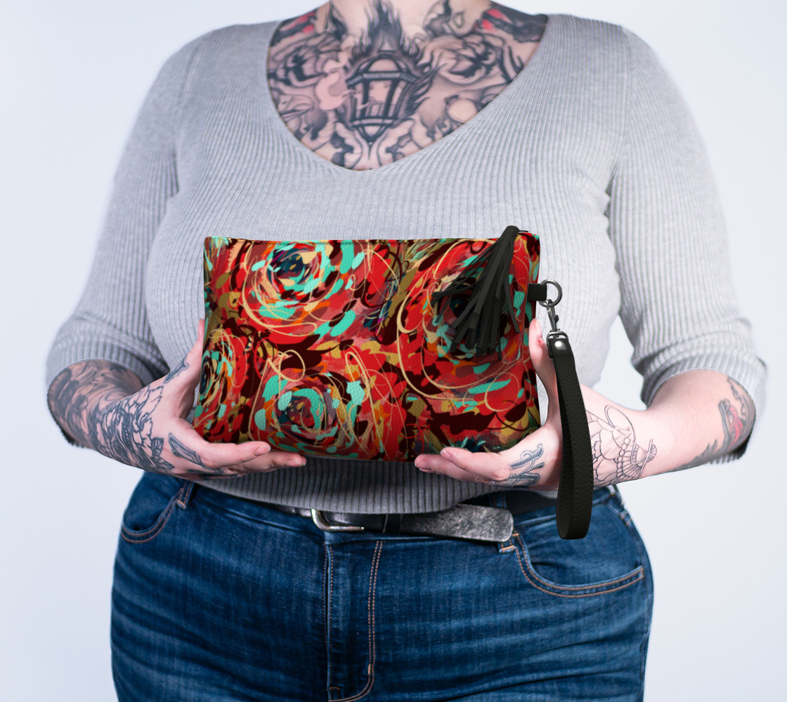 Le Rous Collection Vegan Leather Makeup Bag in Floral, held in hand. This stylish, eco-friendly makeup bag is perfect for keeping your daily essentials organized with its secure zipper closure and chic tassel accent.