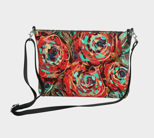 Front view of the Le Rous Collection vegan leather crossbody purse, featuring vibrant red roses and bold teal accents, printed on luxurious textured vegan pebble leather, offering a chic and eco-friendly accessory.