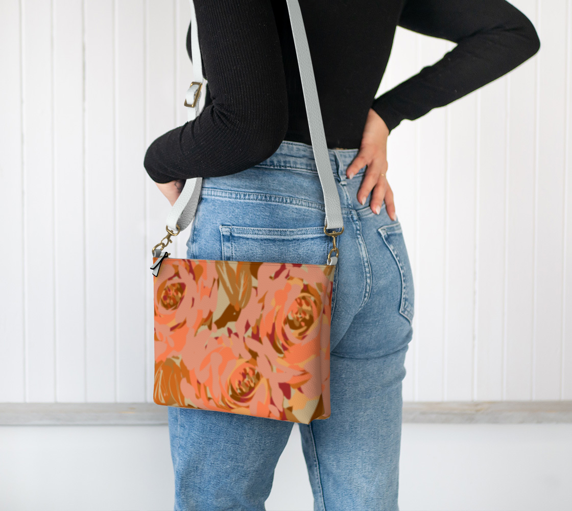 Queen of Petals Copper Sunset Vegan Leather Crossbody, worn on shoulder, demonstrating adjustable strap