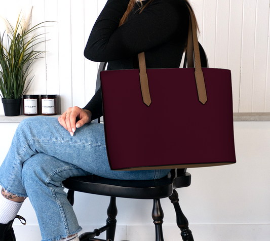 Queen of Petals Darkest Merlot Tote Bag worn on shoulder, darkest merlot burgundy leather with brown straps