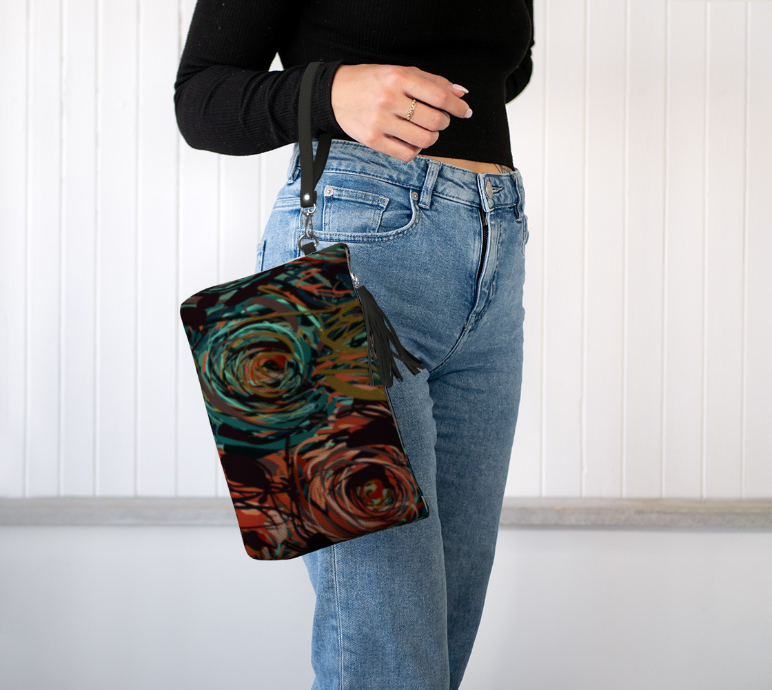 Queen of Petals Patina Clutch worn on wrist with detachable strap and tassel detail
