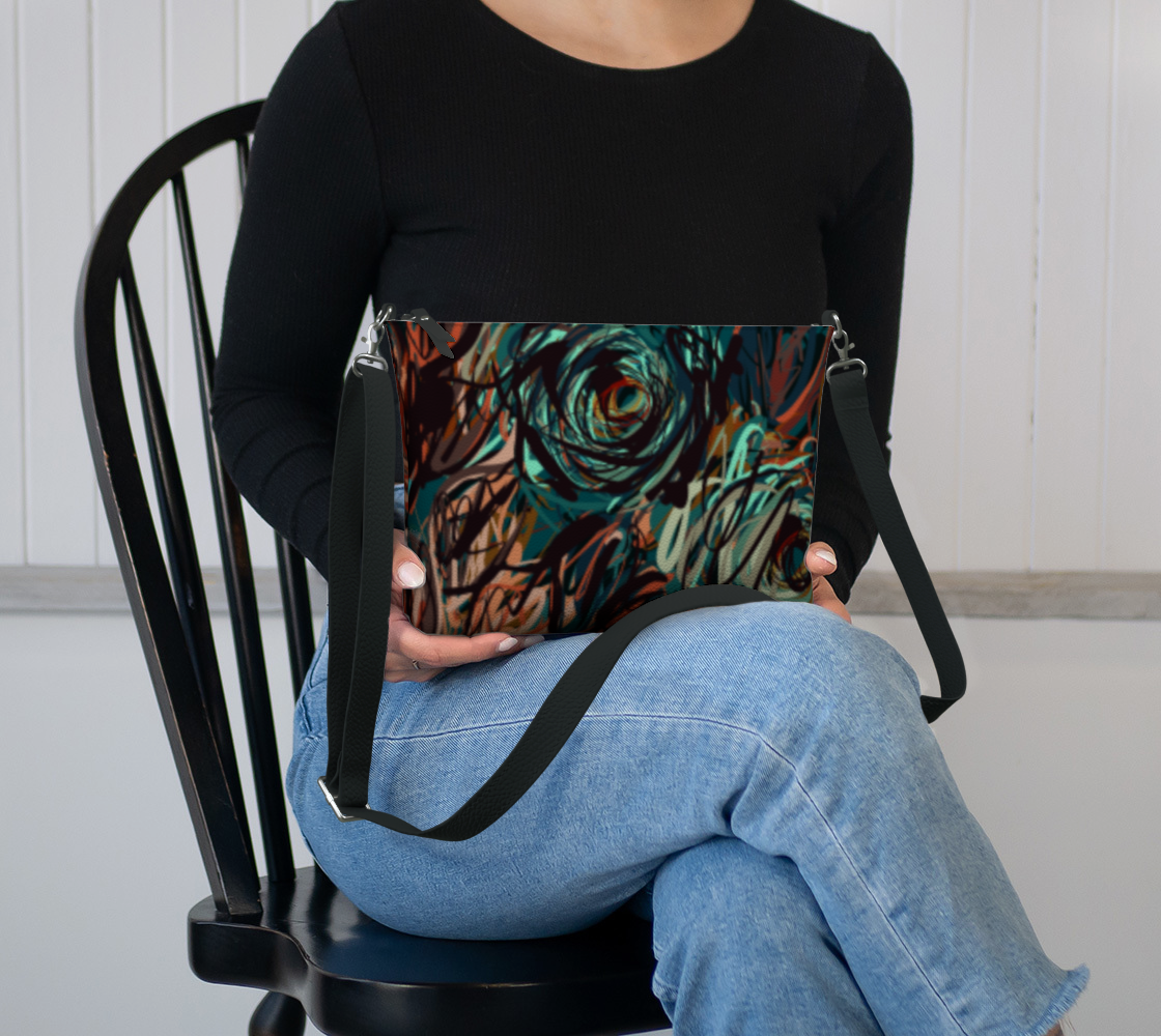 Queen of Petals Patina Crossbody sitting in lap showing navy lining and compact size