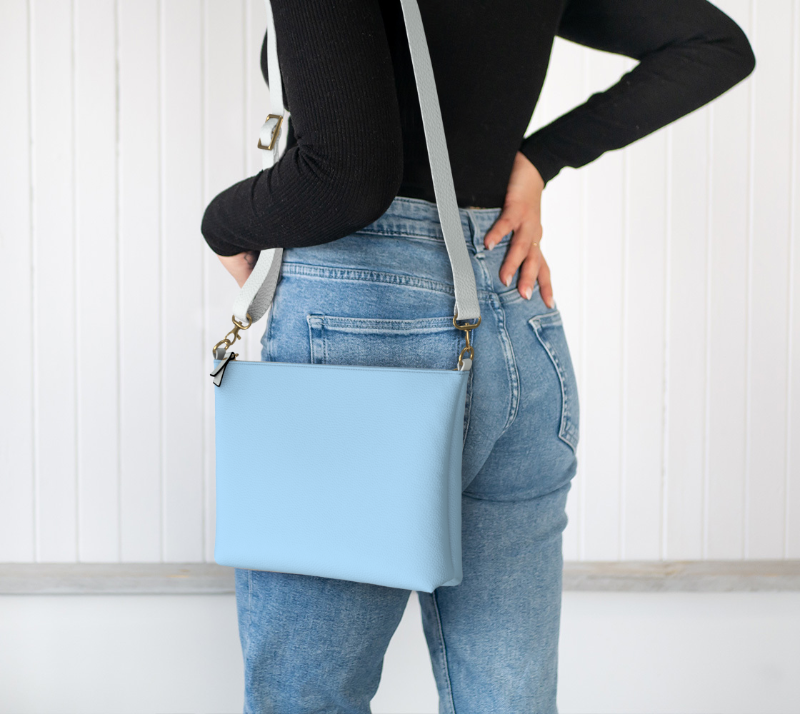 Queen of Petals Shore Blue Powder Blue Crossbody, worn crossbody on shoulder, adjustable strap shown