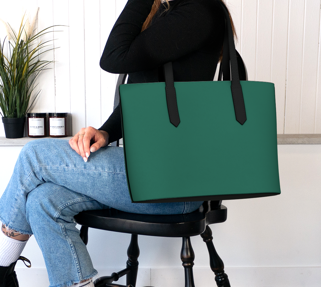 Queen of Petals The Herbarium Rich Jade Tote, worn on shoulder showing volume capacity for botanical research materials