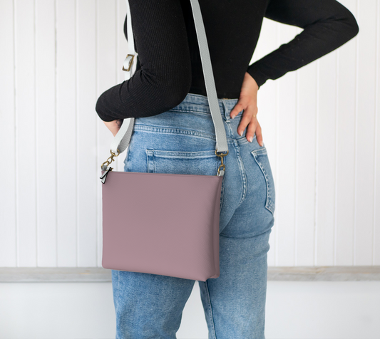 Queen of Petals The Keeper Rose Taupe Crossbody, worn on shoulder with adjustable strap, rose taupe color