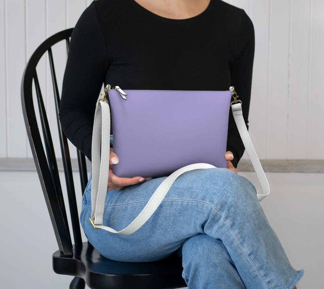 Queen of Petals The Steward Amethyst Crossbody Purse, sitting in lap, showing size and proportion