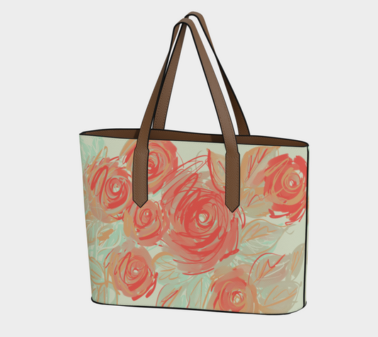 Front view of Xyla vegan leather tote bag featuring coral rose artwork with earthy green accents from Queen of Petals