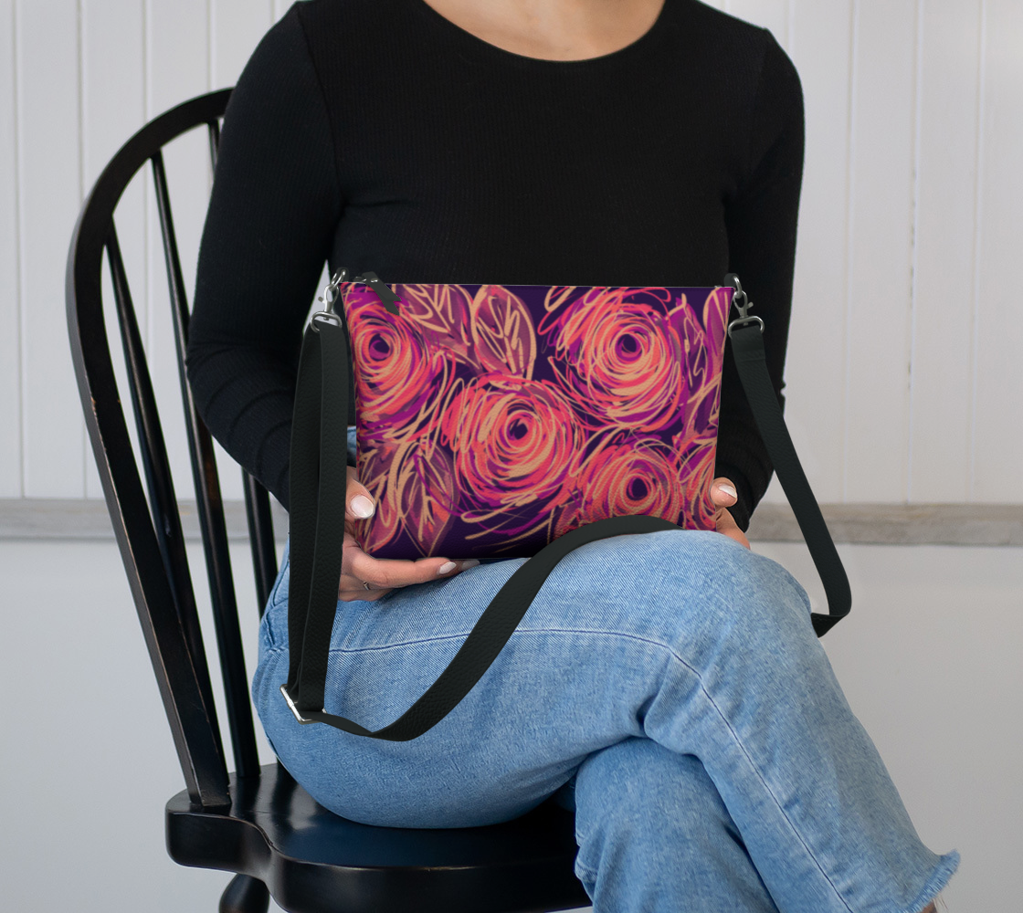 Yvaine Crossbody Purse in lap showing compact size perfect for phone, cards and essentials with bold floral art design